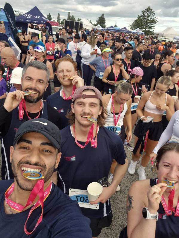 robert-mann-team-celebrates-sutherland-to-surf-2026 Robert Mann team members celebrating after completing the 2026 Sutherland to Surf with their finisher medals.